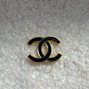 Elegant Black and Gold Interlocking Logo Brooch